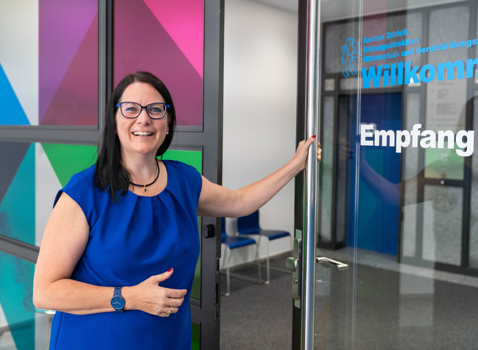 Die Berufsinspektorin vom Mittelschul- und Berufsbildungsamt öffnet die Eingangstür vom Gebäude.
